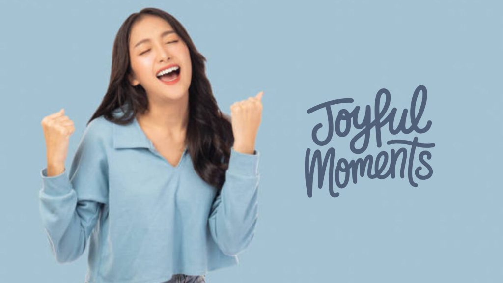 Smiling woman celebrating with 'Joyful Moments' written next to her