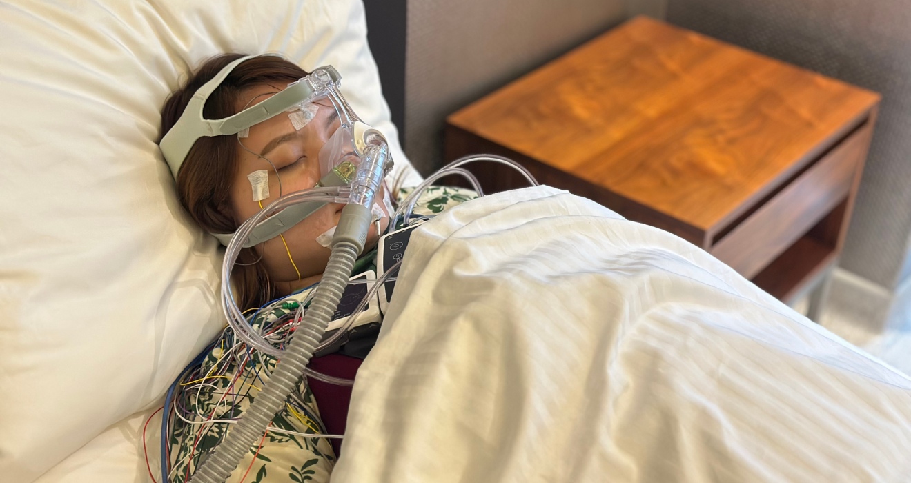 Patient undergoing a Level 1 sleep study with monitoring sensors and a PAP mask